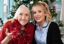 Clinical Care Practitioner Erin Jones having festive fun with resident Eve Flint, 87, at Pendine Park’s Bryn Seiont Newydd care home in Caernarfon.