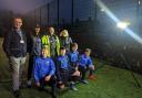 L-R: Police and Crime Commissioner Andy Dunbobbin, Bangor Saints Coaching Coordinator Daf Roberts, North Wales Police PCSO David Griffiths and Gwynedd High Sheriff Janet Phillips with players of the Bangor Saints U13 football team.
