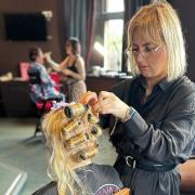 Elle Maguire cutting a client’s hair at her salon, The Hair Bar in Bangor.