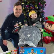 T? Gobaith fundraiser Andy Everley and Dan who attends the hospice with a small selection of the toys.
