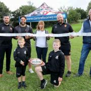Back (L-R): RGC general manager Alun Pritchard, player Jessie Williams, Sharon Jones, RGC head coach Ceri Jones, and Cartrefi Conwy Group chief executive Andrew Bowden. Front (L-R): brothers Harry and Oliver Groves, aged six and 10.