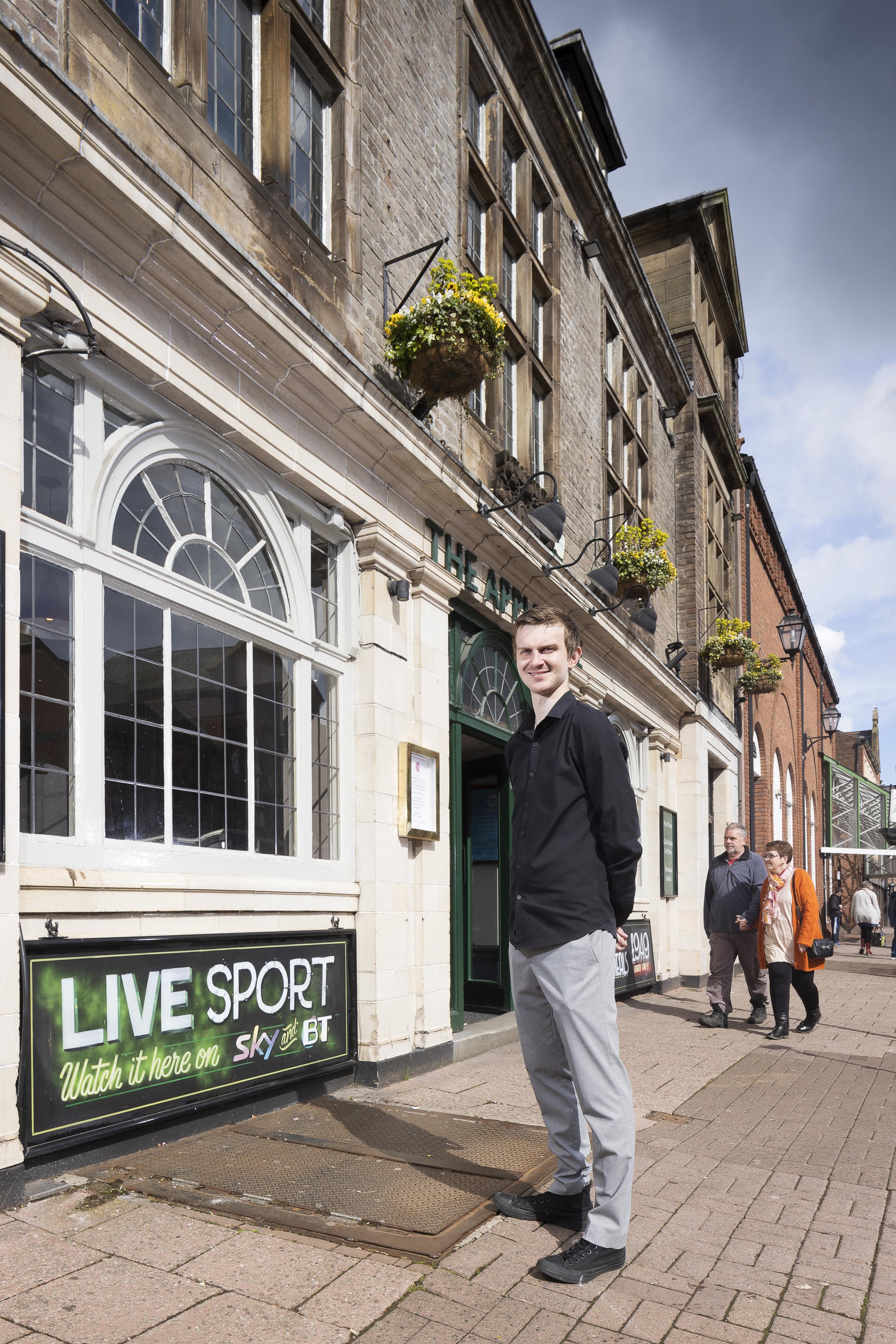 State Managed Pub Scheme Carlisle. The Apple Tree, 55 Lowther St, Carlisle, Cumbria. Exterior, portrait of Dylan McKenzie, Manager, outside The Apple Tree pub on Lowther St, Carlisle, just before re-opening on 17 May 2021 after the Covid-19 pandemic has