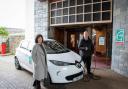 Gwynedd cabinet members Cllr Catrin Wager and Cllr Gareth Griffith with one of the council's electric vehicles