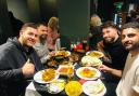 Kem Cetinay (top right) pictured during his meal with friends at Caernarfon Tandoori.