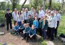 A group shot with children, PCC, Scout volunteers, PCSO Carwyn Gilford, District Commissioner Stephen Buckley, and Police Commissioner Andy Dunbobbin.