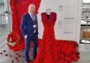 Mabon ap Gwynfor MS with the Gown of Poppies at the Senedd.