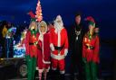 Santa and Mrs Clause accompanied by two elves meeting the mayor Neil Gough.