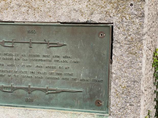 North Wales Chronicle: The vandalised plaque, commemorating the commencement of the road crossing in 1978. Photo: William Day