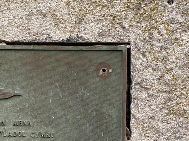 North Wales Chronicle: "These clearly show chisel marks on the plaque itself where the fixings have been hacked off as well as damage to the surrounding stone." Photo: William Day