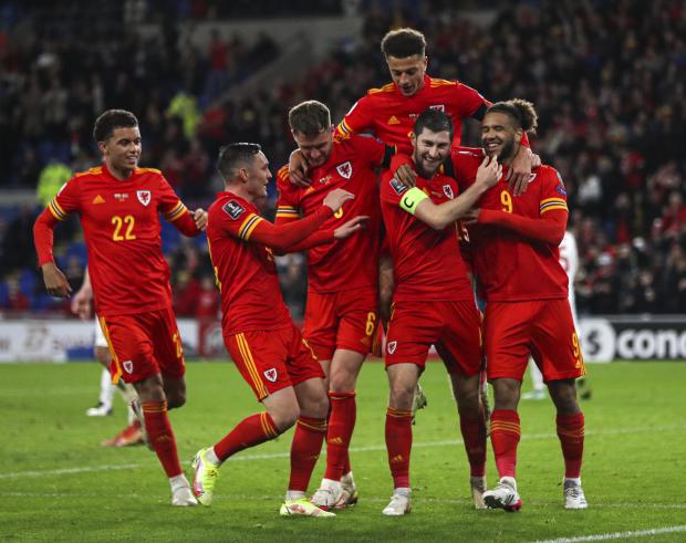 North Wales Chronicle: Wales' Ben Davies (second right) celebrates scoring their side's fourth goal of the game during the FIFA World Cup Qualifying match at the Cardiff City Stadium, Cardiff. Picture date: Saturday November 13, 2021.