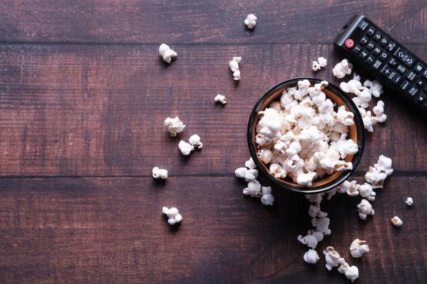 North Wales Chronicle: A bowl of popcorn and a TV remote (Canva)