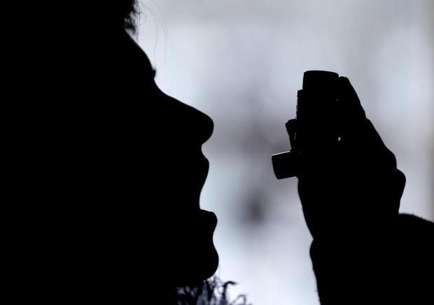 North Wales Chronicle: Silhouette of a person using an inhaler. Credit: Canva