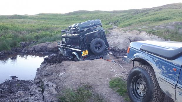 North Wales Chronicle: The 4x4 being winched out of the mud. Photo: North Wales 4x4 Response Group