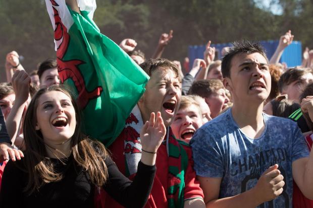 North Wales Chronicle: Supporters watching Wales play Northern Ireland during Euro 2016 at the fanzone in Cardiff (Image: Huw Evans Picture Agency).