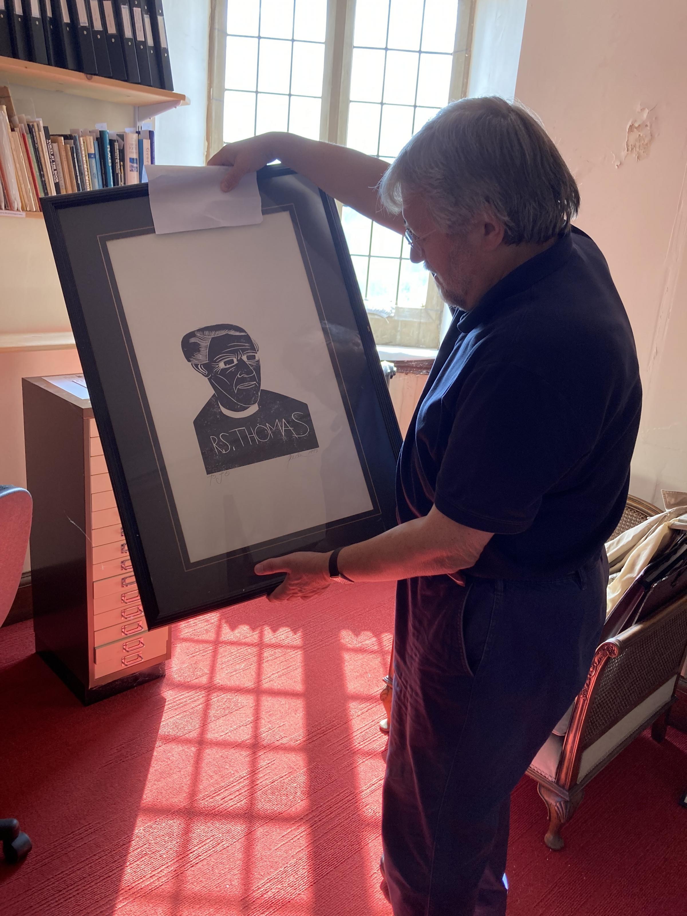Professor Emeritus Tony Brown surveys one of the portraits at the R.S. Thomas Study Centre. Picture: Dale Spridgeon