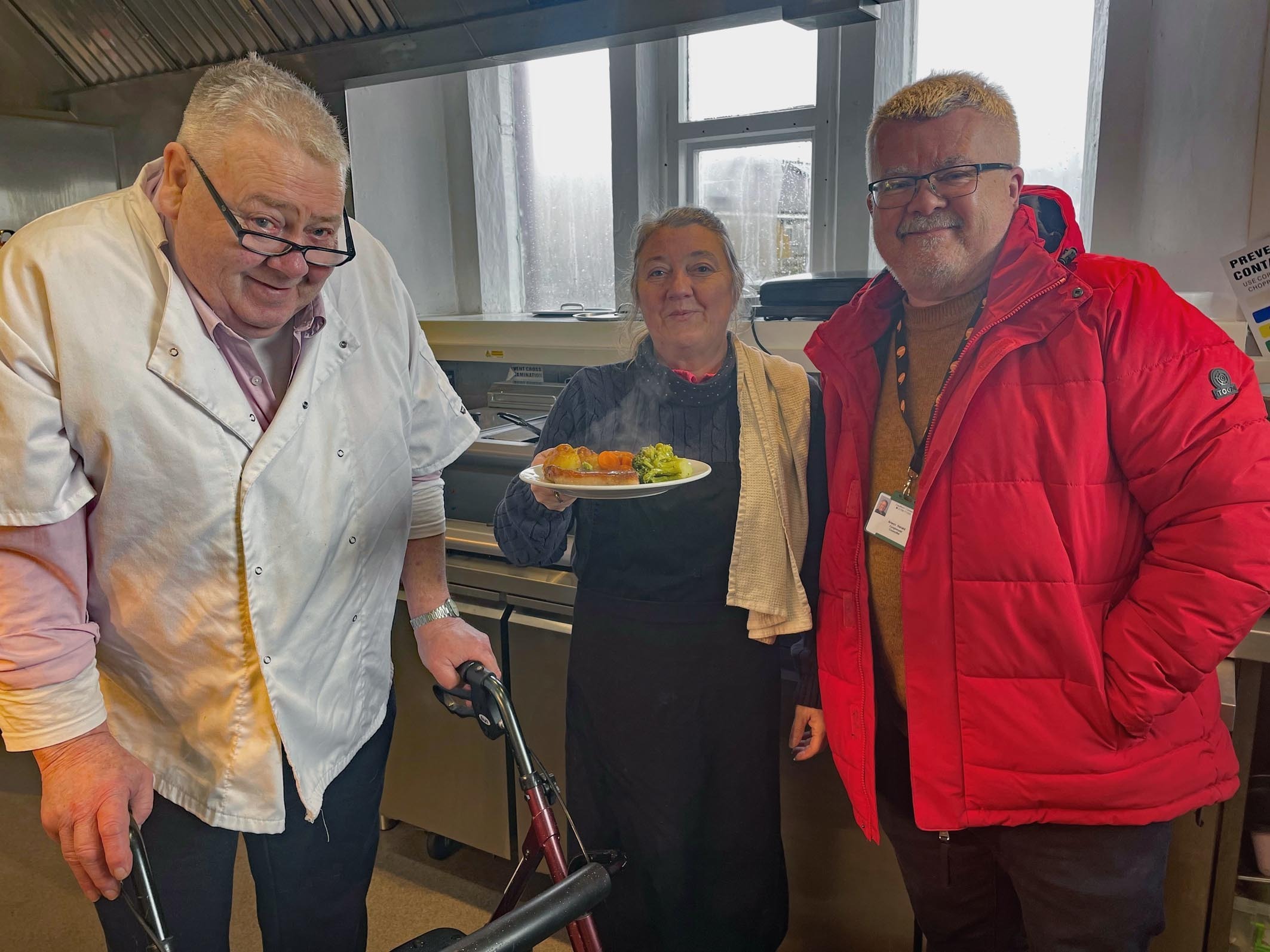 Pictured: The chefs busy are in the kitchen at Canolfan y Fron during a visit by County Councillor Arwyn \Herald\ Roberts (Image: Ffion Clwyd Edwards)