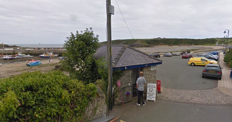 The harbour and beach side cafe and parking kiosk at Cemaes (Image Google Map)