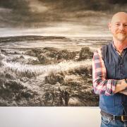 Darren Hughes with his 'Native Places' work, which features a variety of artistic processes.