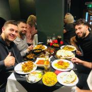 Kem Cetinay (top right) pictured during his meal with friends at Caernarfon Tandoori.
