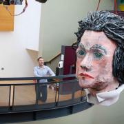 The Giant Beethoven head suspended above the foyer at Galeri in Caernarfon with international concert pianist Iwan Llewelyn Jones (right) and artist Catrin Williams