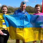 Cheryl Frost and Kay Hatton with a race official at the Ukraine appeal run