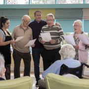 (L/R) Forget-me-not Chorus Music Leader Rebeca Kirkby, resident Elwyn Williams, Emyr Gibson, BSN enrichment team, residents David Edwards and Margaret Rotheram and Bryn Seiont Newydd’s musician-in-residence Nia Davies Williams. Photo: Mandy Jones