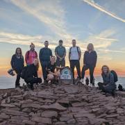 The team at the summit of Pen y Fan, the first of the three peaks they completed.