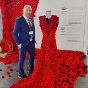 Mabon ap Gwynfor MS with the Gown of Poppies at the Senedd.