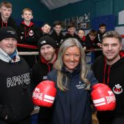 Caren Jones, of Harlech Foodservice who have donated £800 to Caernarfon Boxing Club, pictured with, from left, Ian Owen, head coach, assistant coaches Sion Davies and Delme Davies, and young boxers.