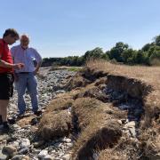 Gareth Phillips and Dr Nick Stuart look at the crumbling edge of the Lleiniog beach car park on Anglesey which is being impacted by rapid sea erosion (Image Dale Spridgeon)