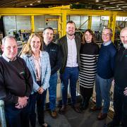 Mona Group directors Steven Jones, Gethin Rees Jones and Robin Evans alongside MP for Ynys Môn, Virginia Crosbie and representatives of the Green Digital Academy on-site at Mona Group HQ in Llangefni.