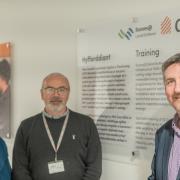 Rhianwen Edwards, director of commercial and work-based learning, Gareth Hughes, manager of CIST Centre and innovation and Dafydd Evans, chief executive of Grŵp Llandrillo Menai pictured at Tŷ Gwyrddfai.